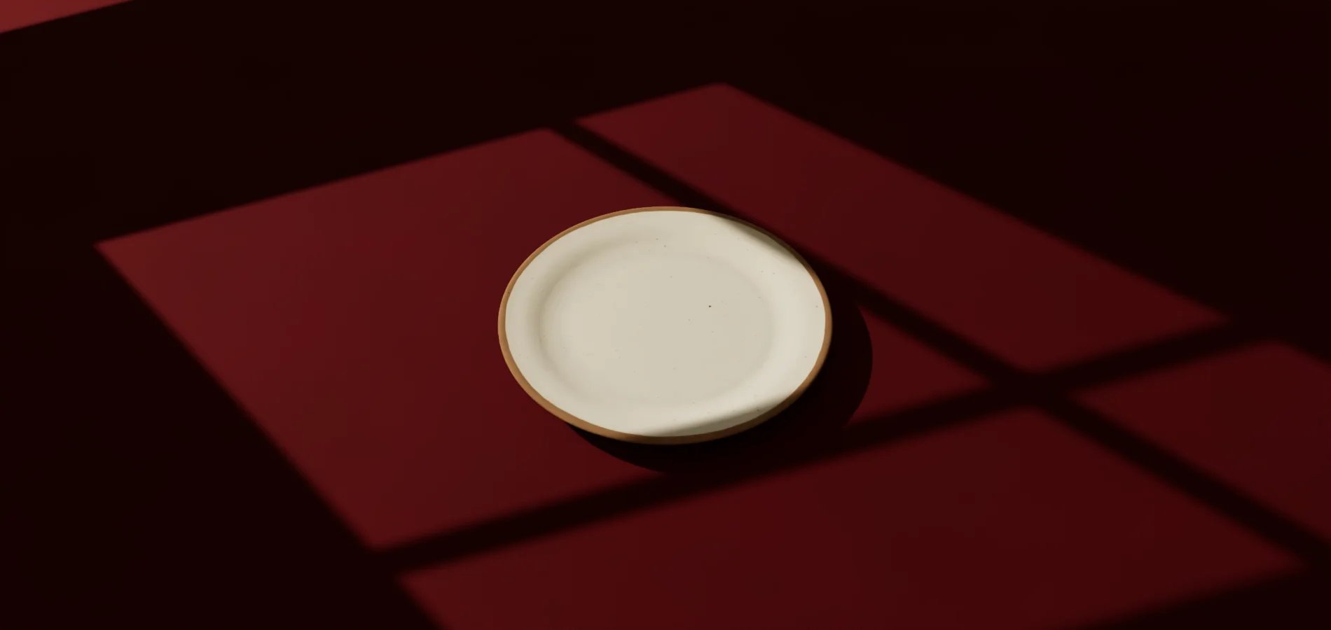 Plato vacío de gres sobre papel rojo oscuro, con luz lateral de ventana, pintado por el plató 3D.